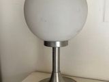 a lamp that is sitting on a table next to a window