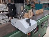 an image of a machine that is working on a piece of wood