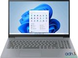 un gros plan d'un ordinateur portable posé sur une surface blanche, avec un fond bleu