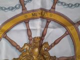 a picture of a table cloth with a ship wheel on it