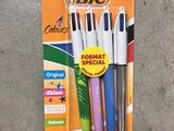 three different colored pens are in a package on the floor
