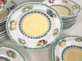 many plates and bowls that are sitting on a table