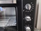 a small black toaster oven sitting on a counter