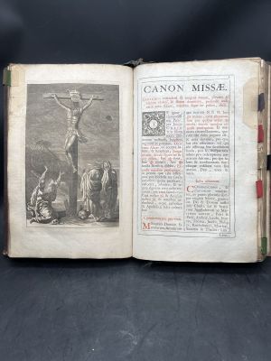 an old book with a picture of a crucif on it