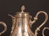 three silver teapots sitting on top of a table next to each other