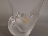 a glass bird that is sitting on a table