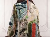 an image of a jacket on a mannequin stand in front of a white wall