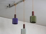 four different colored lights hanging from the ceiling in a room