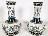 two vases that are sitting on a table