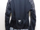 the back of a black jacket hanging on a white wall