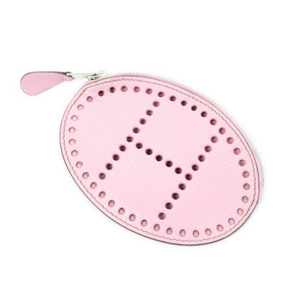 pink leather coin purse with a cross on the front
