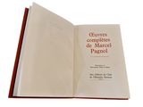an open book on a white background with a red cover
