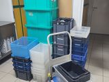 many plastic containers sitting on the floor in a room
