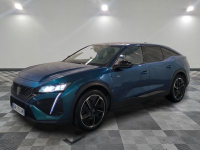 a blue suv parked on a checkered floor in a garage