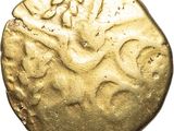 a gold coin with a design on it on a white background