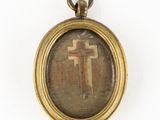 an image of a cross is displayed in a gold frame