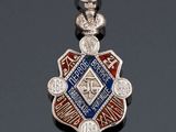 a close up of a silver and blue medal on a black surface