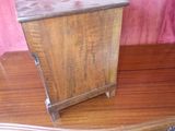 a small wooden box sitting on top of a wooden table