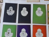 a table with a bunch of cards on it with pictures of clowns