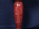 a red marble pedestal with a wooden base on a blue background