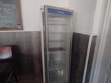 a refrigerator in the corner of a room with a chalkboard on the wall