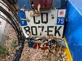 a blue truck that has a license plate on the back of it