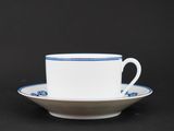 a close up of a cup and saucer on a black background