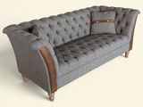 a gray couch with a brown leather arm rest