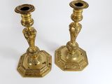 pair of antique brass candlesticks on a white background
