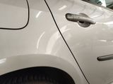 a close up of a car door handle with a child looking at it