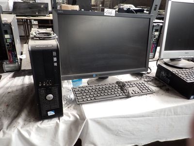 a desk with a computer and a keyboard on it
