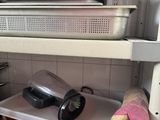 many pots and pans on the shelves in the kitchen