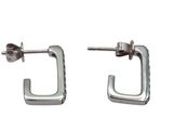 a pair of silver earrings with a square design on them