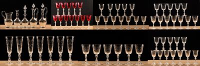 many wine glasses lined up on a shelf