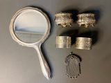 a mirror, a ring, and other items that are on a table