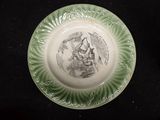 a green plate with a picture of a woman on it