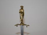 a statue of a woman holding a sword on top of a table