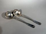 two spoons that are sitting on a table