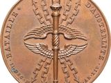 an image of a bronze medal with a sword on it