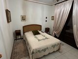 a bedroom with a bed and a chandelier hanging from the ceiling