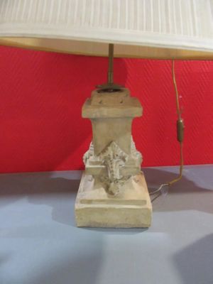 a lamp that is sitting on a table next to a red wall