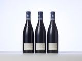 three bottles of wine sitting on top of a table next to each other