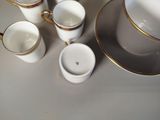 four cups and a saucer sitting on a table
