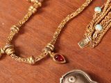 a gold necklace with a picture of a woman on it