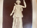 an old picture of a statue of a woman on a pedestal