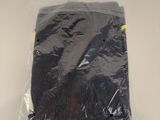 a bag of black clothing on a white surface