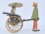 two figurines of a man and a woman with an umbrella