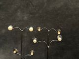 pair of metal and glass candle holders with pearls on each of them