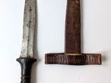 two knives that are on the wall next to each other
