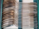 a lot of spoons and forks in a blue box